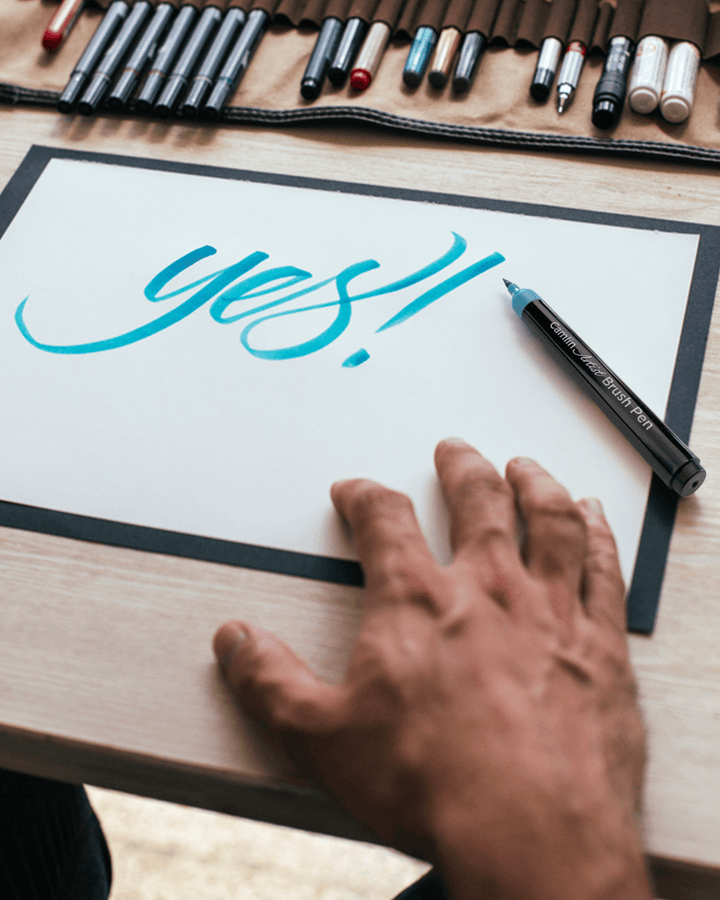 Yes written on Paper With Blue Camlin Artist Brush Pen