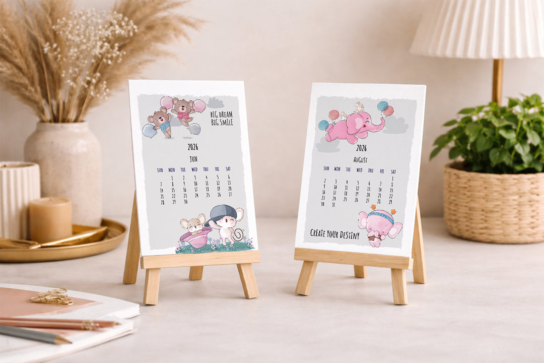 Two small calendars on stands with decorative elements on a table.