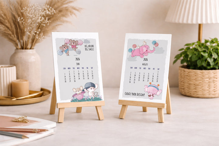 Two small calendars on stands with decorative elements on a table.