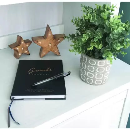 Grey Colour Creative Convert Goals Journal kept on table beside pot 